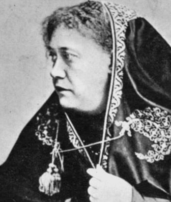 Historical profile photograph of H.P. Blavatsky with an embroidered dark head covering.