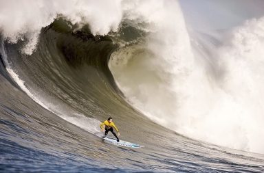 Surfer balancing on a giant ocean wave illustrating the strategic science of opportunities in a fluid environment.