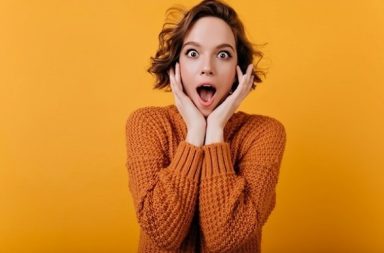 Shocked expression of a young woman looking sideways, representing the reaction when sharing your spiritual journey.